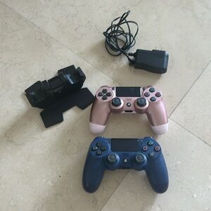 PS4 Dual Shock Controllers (2/ pink and Blue) with charging station included